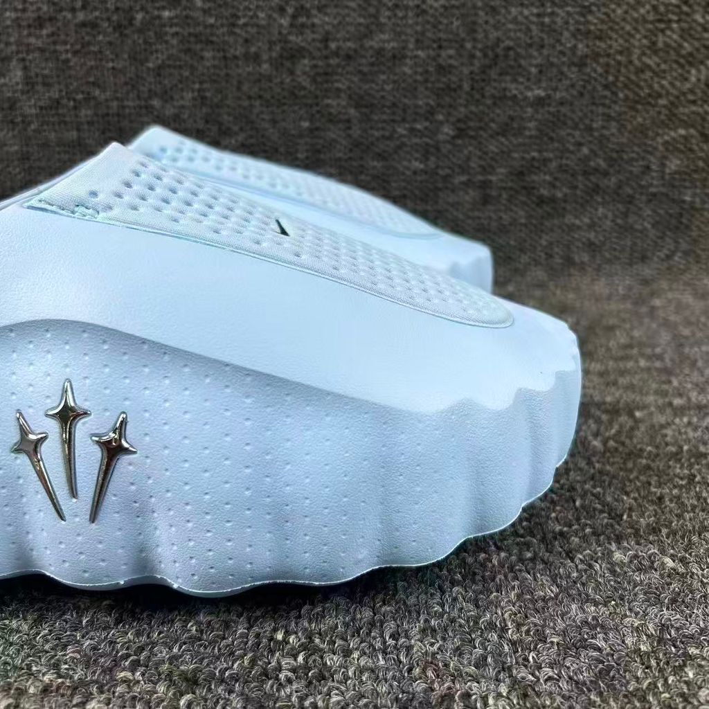 Nike x NOCTA Mind 001 premium lifestyle slide in a vibrant Ice Blue, featuring a tactical, tech-wear inspired molded upper and subtle NOCTA branding.