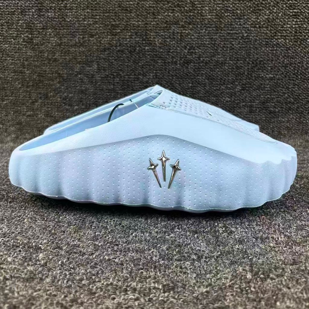 Nike x NOCTA Mind 001 premium lifestyle slide in a vibrant Ice Blue, featuring a tactical, tech-wear inspired molded upper and subtle NOCTA branding.