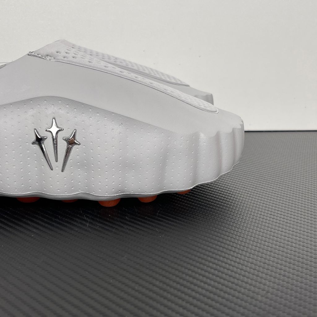 Nike x NOCTA Mind 001 premium lifestyle slide in a monochromatic light grey, featuring a tactical, tech-wear inspired molded upper and subtle NOCTA branding.