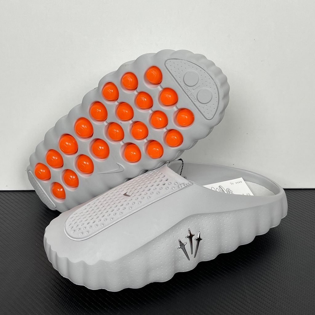 Nike x NOCTA Mind 001 premium lifestyle slide in a monochromatic light grey, featuring a tactical, tech-wear inspired molded upper and subtle NOCTA branding.