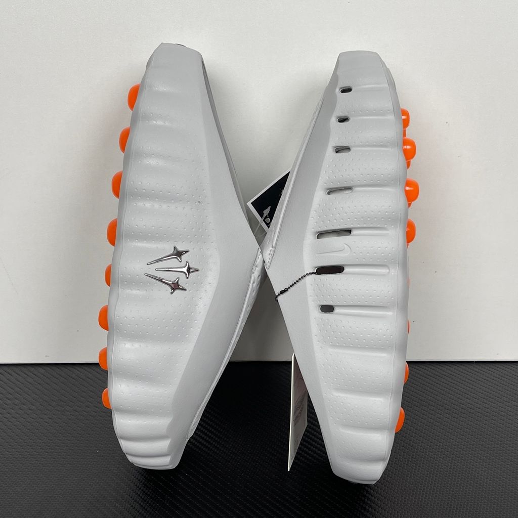 Nike x NOCTA Mind 001 premium lifestyle slide in a monochromatic light grey, featuring a tactical, tech-wear inspired molded upper and subtle NOCTA branding.