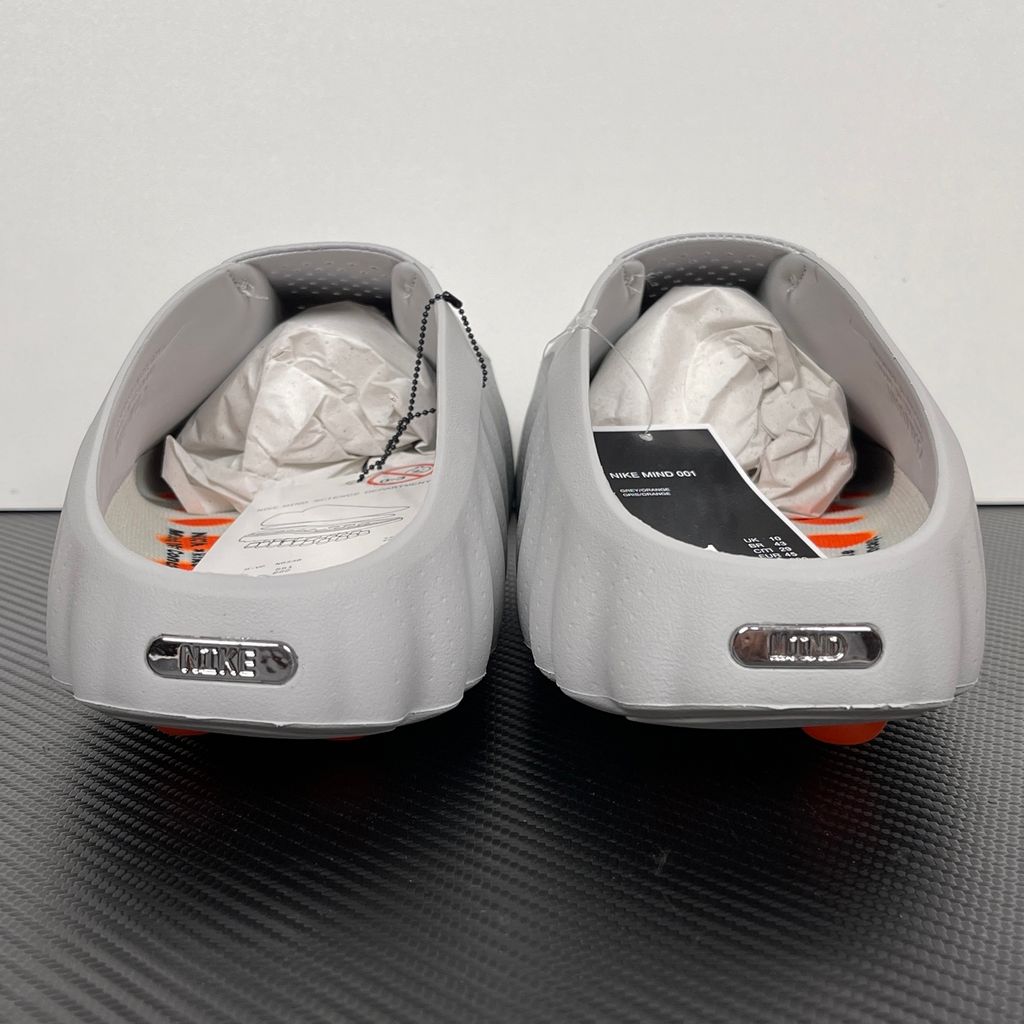 Nike x NOCTA Mind 001 premium lifestyle slide in a monochromatic light grey, featuring a tactical, tech-wear inspired molded upper and subtle NOCTA branding.