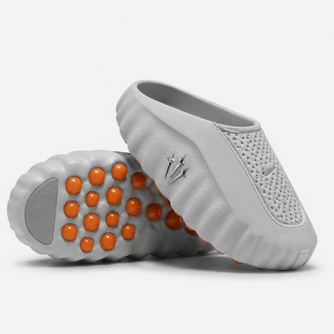Nike x NOCTA Mind 001 premium lifestyle slide in a monochromatic light grey, featuring a tactical, tech-wear inspired molded upper and subtle NOCTA branding.