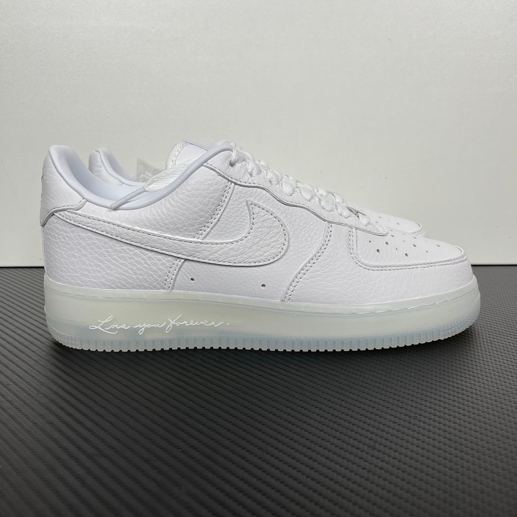 Nike Air Force 1 Low x Drake NOCTA "Certified Lover Boy" sneaker in pristine white premium leather with subtle Cobalt Tint accents and custom NOCTA heel branding, SKU CZ8065-101.