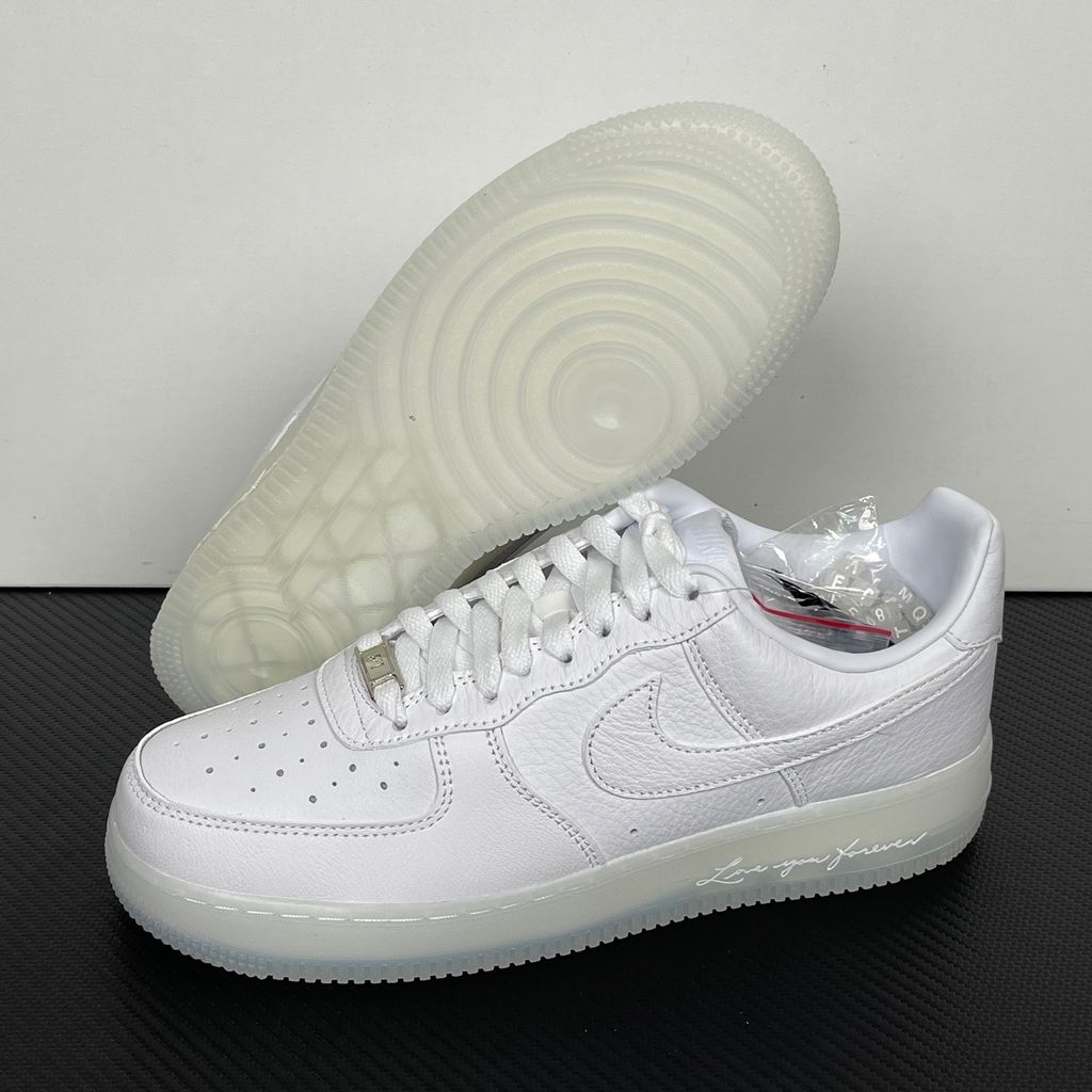 Nike Air Force 1 Low x Drake NOCTA "Certified Lover Boy" sneaker in pristine white premium leather with subtle Cobalt Tint accents and custom NOCTA heel branding, SKU CZ8065-101.