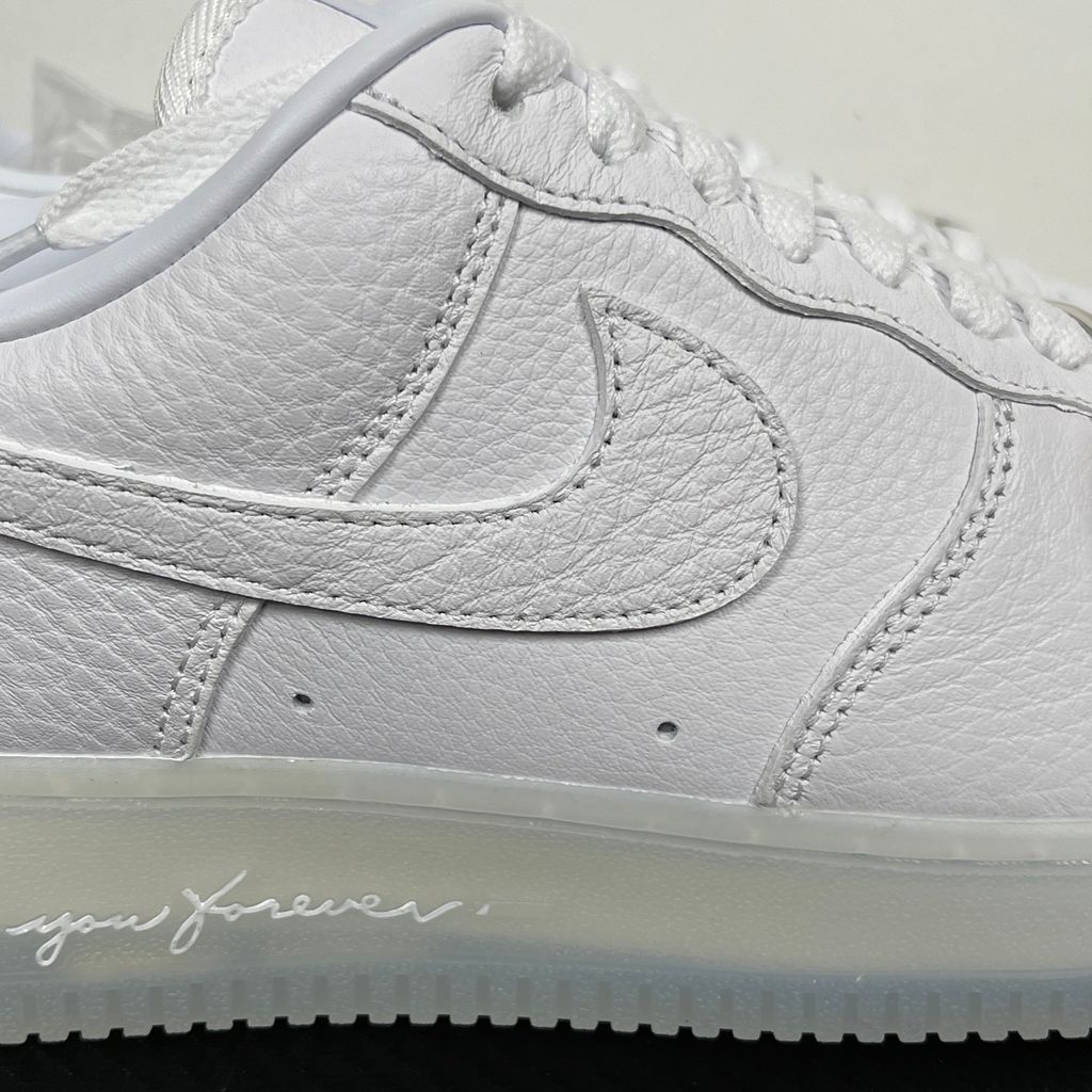 Nike Air Force 1 Low x Drake NOCTA "Certified Lover Boy" sneaker in pristine white premium leather with subtle Cobalt Tint accents and custom NOCTA heel branding, SKU CZ8065-101.