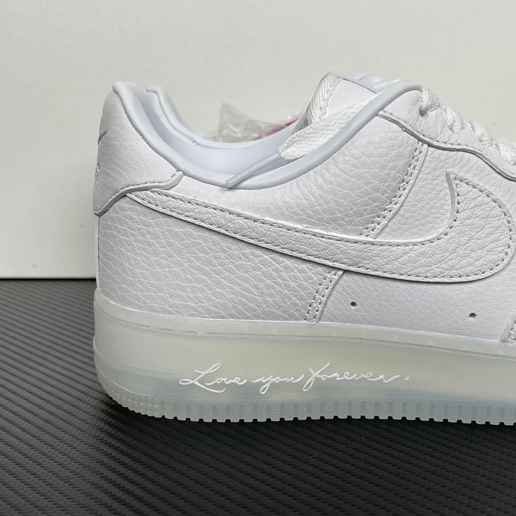 Nike Air Force 1 Low x Drake NOCTA "Certified Lover Boy" sneaker in pristine white premium leather with subtle Cobalt Tint accents and custom NOCTA heel branding, SKU CZ8065-101.