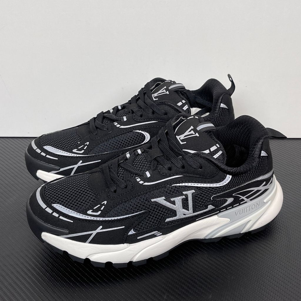 Louis Vuitton Tatic Runner lifestyle sneaker in black mesh and synthetic materials, featuring white and grey accents, prominent LV side logo, and "VUITTON" midsole embossing, SKU 1AKC07.