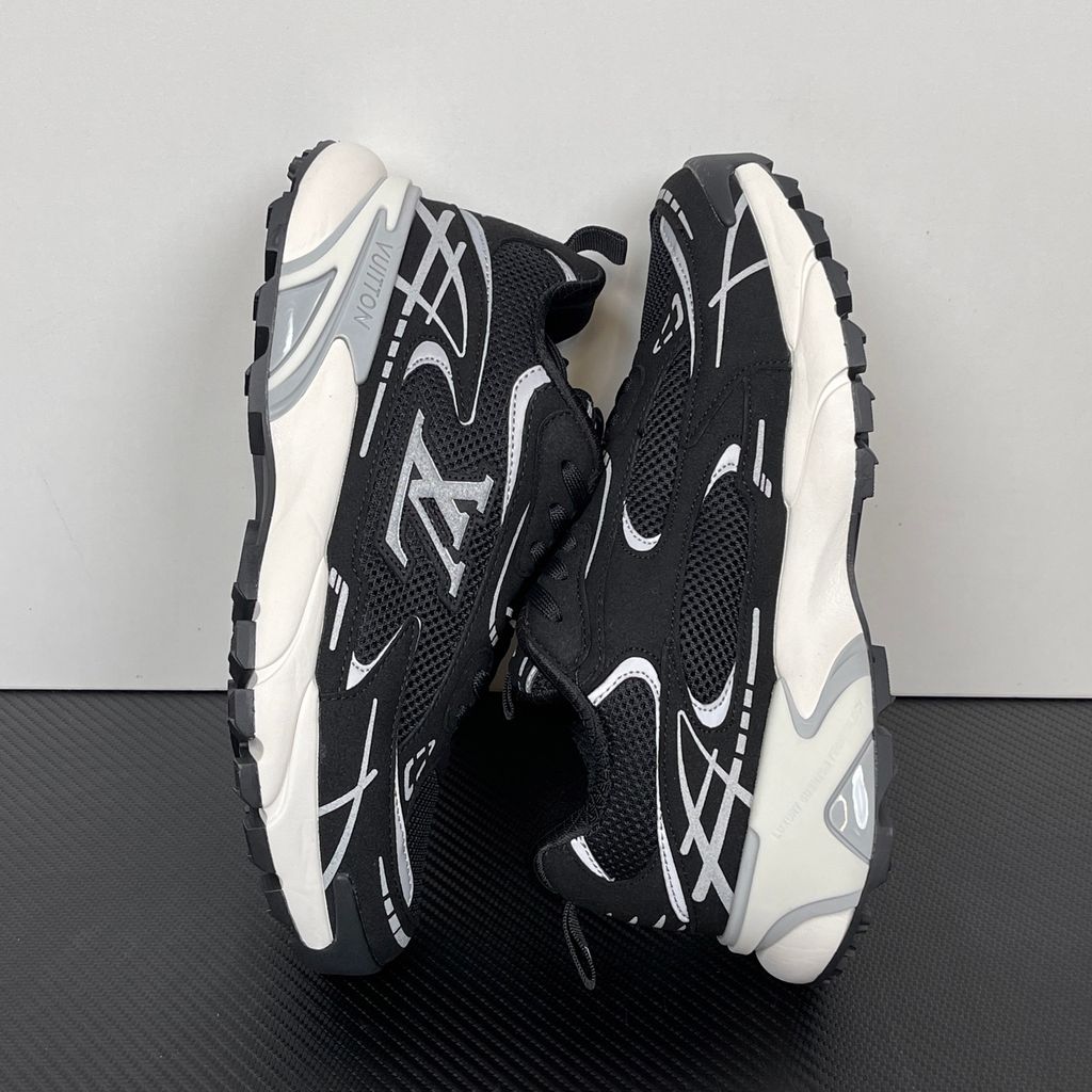 Louis Vuitton Tatic Runner lifestyle sneaker in black mesh and synthetic materials, featuring white and grey accents, prominent LV side logo, and "VUITTON" midsole embossing, SKU 1AKC07.