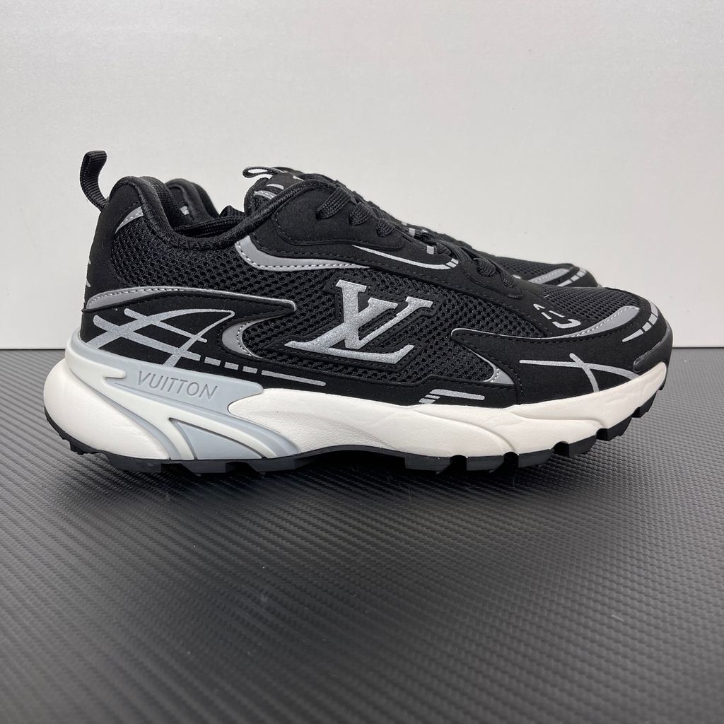 Louis Vuitton Tatic Runner lifestyle sneaker in black mesh and synthetic materials, featuring white and grey accents, prominent LV side logo, and "VUITTON" midsole embossing, SKU 1AKC07.