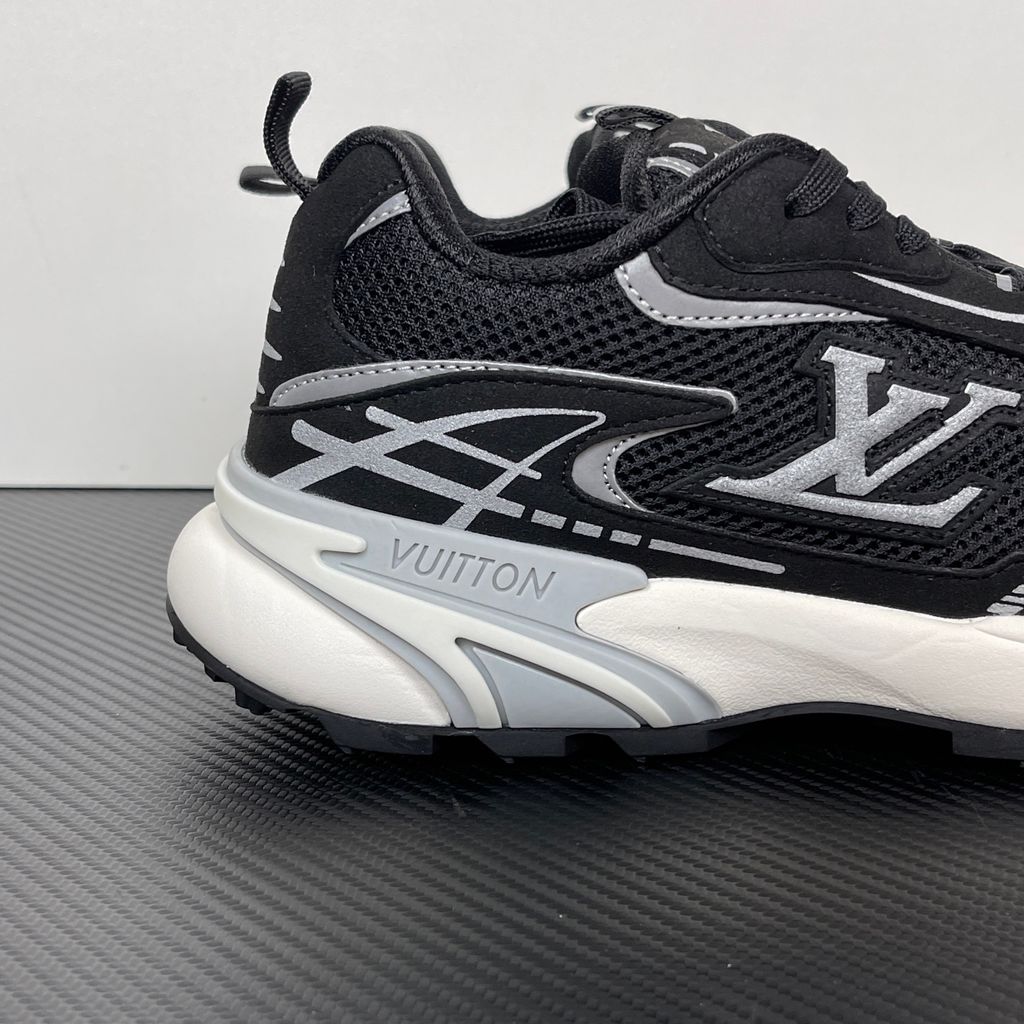 Louis Vuitton Tatic Runner lifestyle sneaker in black mesh and synthetic materials, featuring white and grey accents, prominent LV side logo, and "VUITTON" midsole embossing, SKU 1AKC07.