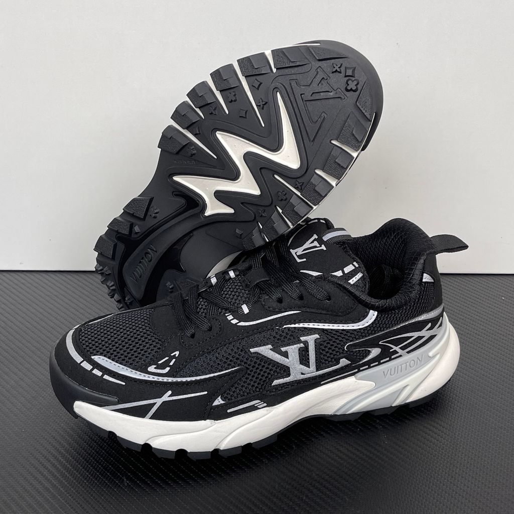 Louis Vuitton Tatic Runner lifestyle sneaker in black mesh and synthetic materials, featuring white and grey accents, prominent LV side logo, and "VUITTON" midsole embossing, SKU 1AKC07.