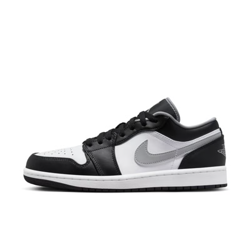 Air Jordan 1 Low lifestyle sneaker featuring a crisp white leather base, black leather overlays, and a neutral grey Swoosh and outsole, SKU 553558-040.