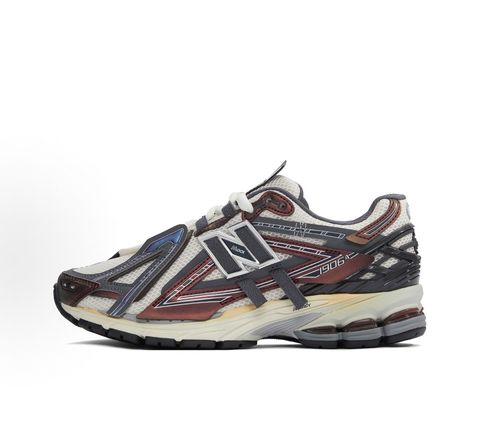 New Balance 1906A tech-runner in a deep "Eggplant" purple colorway, featuring a deconstructed layered mesh and synthetic upper, metallic details, and an ABZORB midsole, SKU U1906ANA.