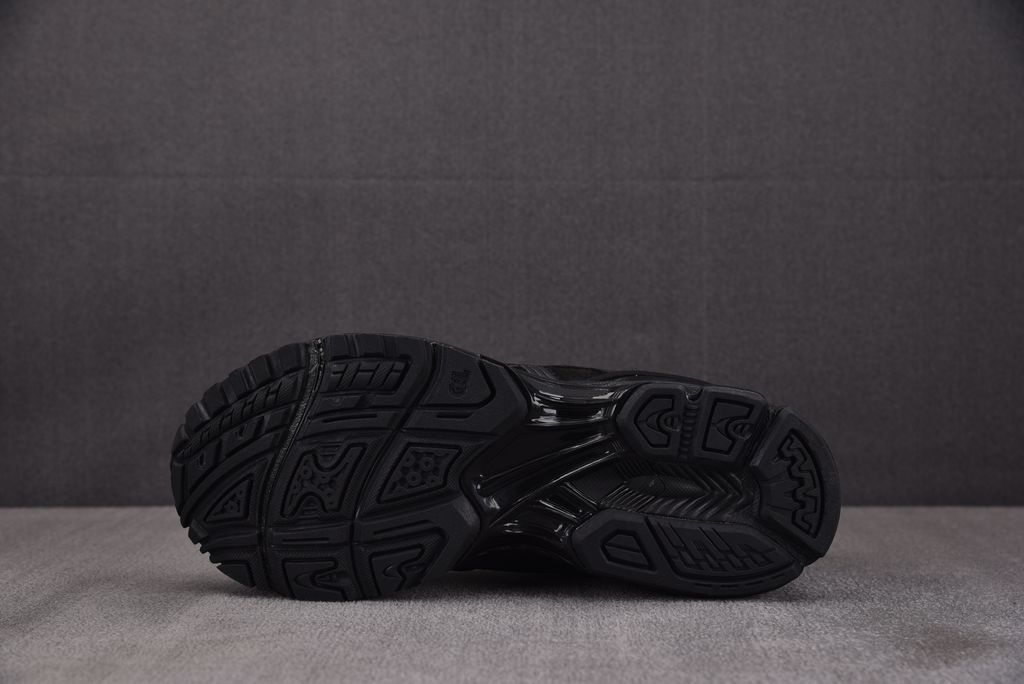 ASICS Gel-Kayano 14 x Thom Browne luxury performance sneaker in a monochromatic black colorway, featuring premium leather and mesh construction, co-branded detailing, and metallic accents, SKU 1203B110-001.