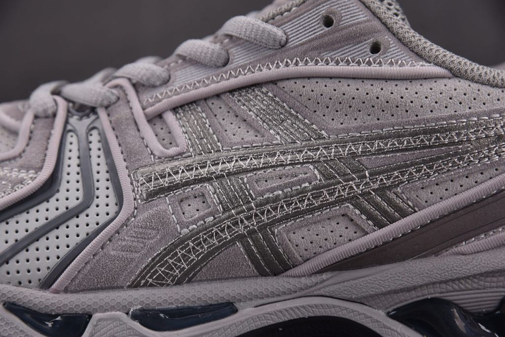 ASICS Gel-Kayano 14 x Thom Browne luxury performance sneaker in a monochromatic grey colorway, featuring premium leather and mesh construction, co-branded detailing, and metallic accents, SKU 1203B110-020.