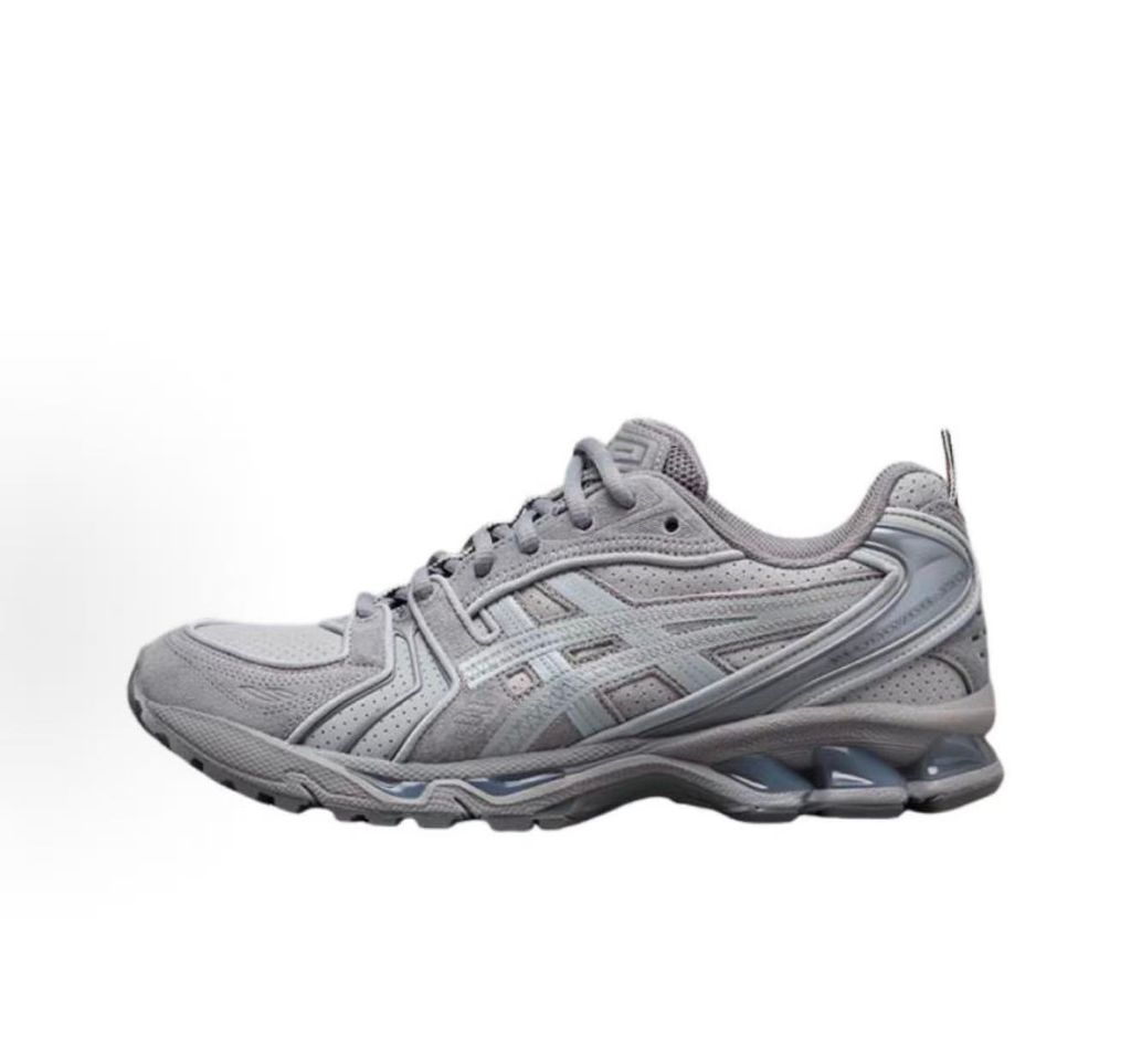 ASICS Gel-Kayano 14 x Thom Browne luxury performance sneaker in a monochromatic grey colorway, featuring premium leather and mesh construction, co-branded detailing, and metallic accents, SKU 1203B110-020.