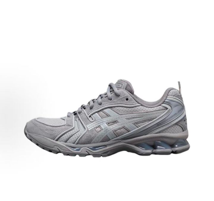 ASICS Gel-Kayano 14 x Thom Browne luxury performance sneaker in a monochromatic grey colorway, featuring premium leather and mesh construction, co-branded detailing, and metallic accents, SKU 1203B110-020.