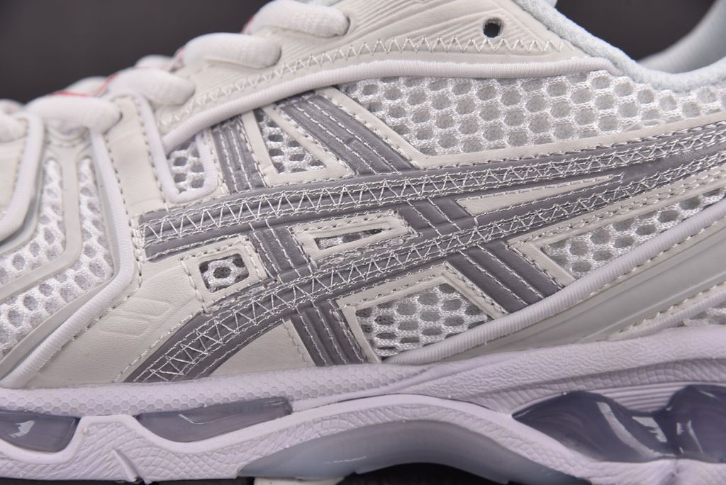 ASICS Gel-Kayano 14 x Thom Browne luxury performance sneaker in a crisp monochromatic white colorway, featuring premium leather and mesh construction, co-branded detailing, and metallic accents, SKU 1203B291-100.