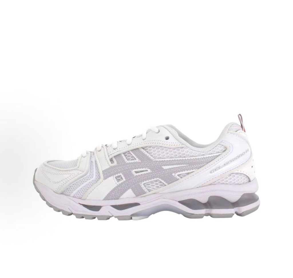 ASICS Gel-Kayano 14 x Thom Browne luxury performance sneaker in a crisp monochromatic white colorway, featuring premium leather and mesh construction, co-branded detailing, and metallic accents, SKU 1203B291-100.