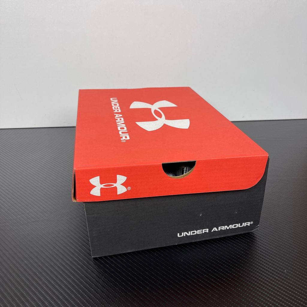 Under Armour UA Sola retro tech-runner side profile, featuring a white breathable mesh upper, dynamic metallic silver synthetic overlays, and vibrant purple accents on the midsole and collar, SKU 6005284-103.