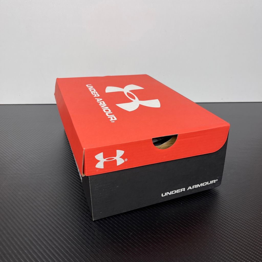 Under Armour UA Sola retro tech-runner side profile, featuring a clean white breathable mesh upper, dynamic metallic silver synthetic overlays, and a chunky white midsole, SKU 6005284-100.