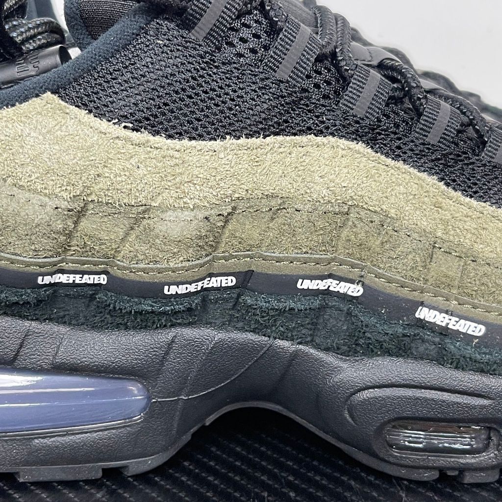 Nike Air Max 95 SP x Undefeated "Geo La Brea" sneaker featuring a layered gradient upper in Medium Olive and dark green tones, premium suede construction, and a contrasting black midsole, SKU IB4523-200.