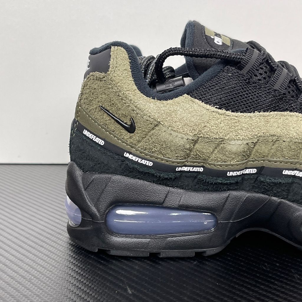 Nike Air Max 95 SP x Undefeated "Geo La Brea" sneaker featuring a layered gradient upper in Medium Olive and dark green tones, premium suede construction, and a contrasting black midsole, SKU IB4523-200.