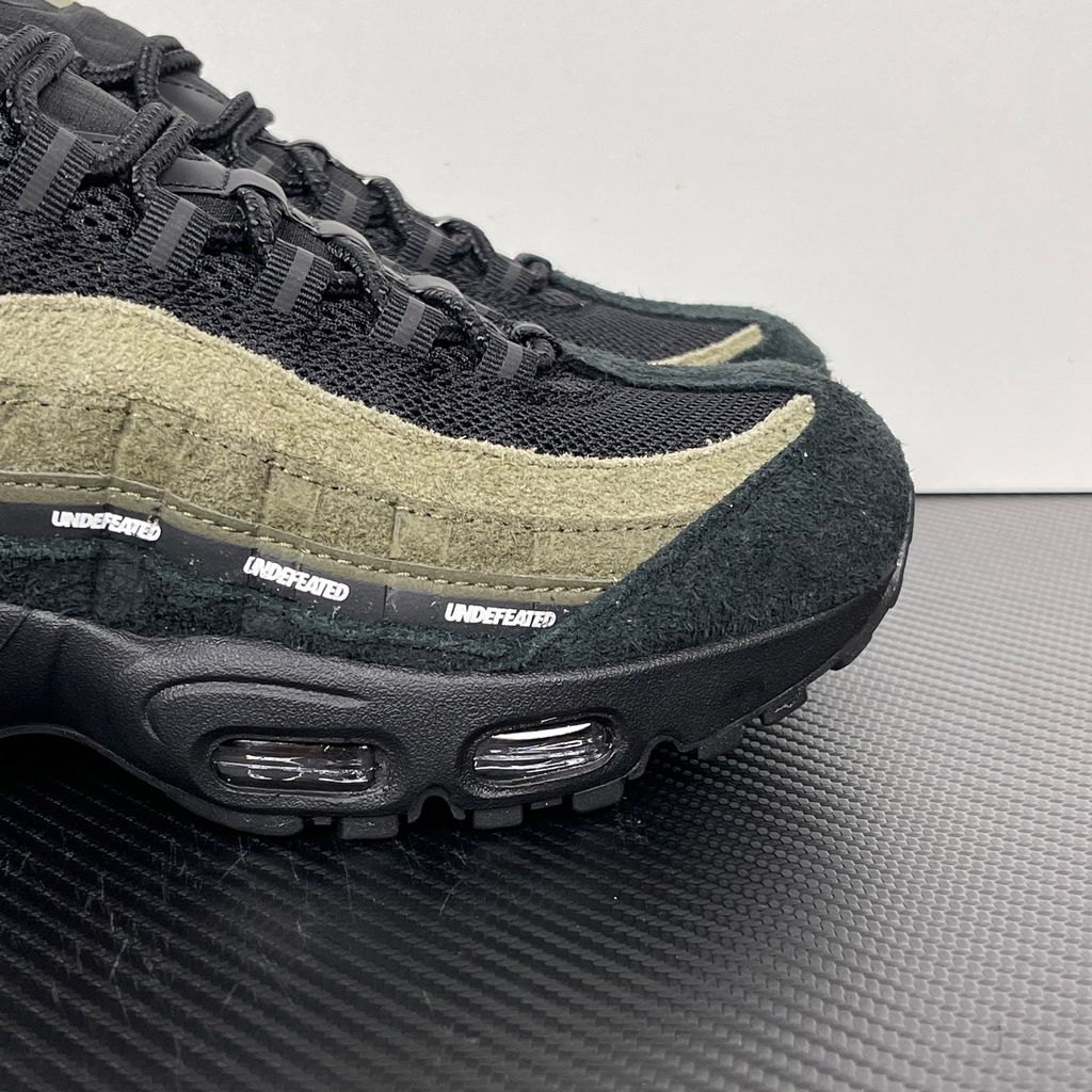 Nike Air Max 95 SP x Undefeated "Geo La Brea" sneaker featuring a layered gradient upper in Medium Olive and dark green tones, premium suede construction, and a contrasting black midsole, SKU IB4523-200.