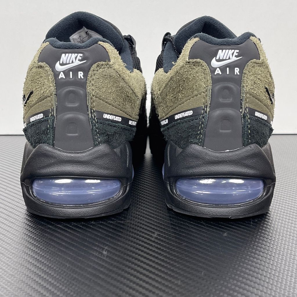 Nike Air Max 95 SP x Undefeated "Geo La Brea" sneaker featuring a layered gradient upper in Medium Olive and dark green tones, premium suede construction, and a contrasting black midsole, SKU IB4523-200.