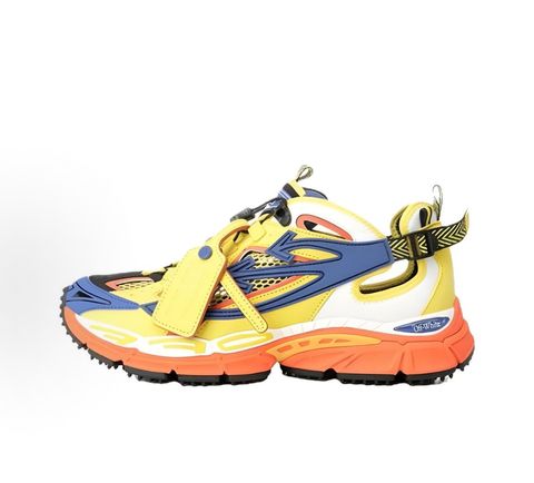 Side profile of the Off-White "Be Right" sneaker featuring a vibrant yellow mesh upper, bold blue signature arrow overlays, a chunky orange sculpted midsole, and black technical heel straps.