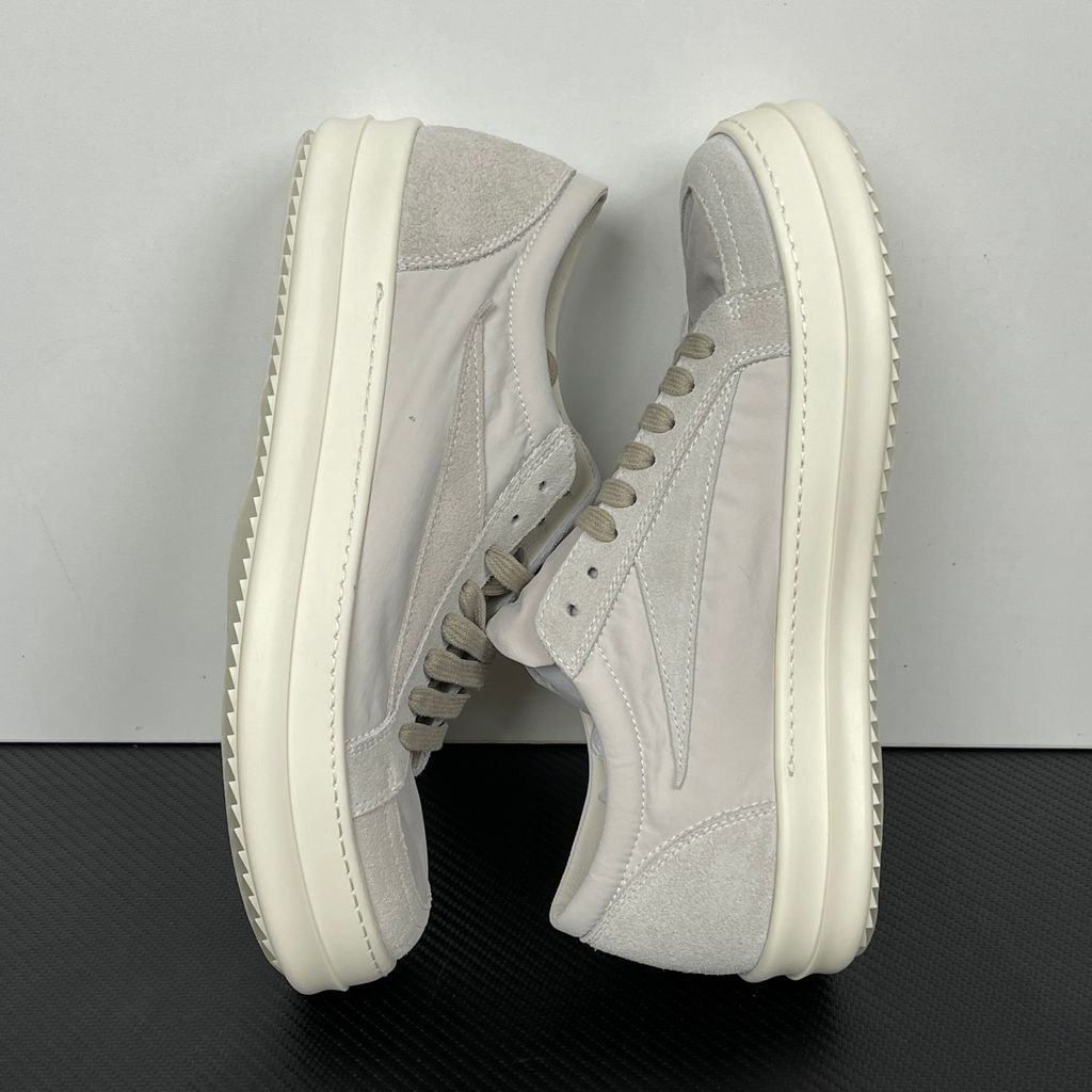 Side profile of the Rick Owens Mainline Vintage Sneaks in Pearl/Milk, featuring a sleek low-top silhouette with luxurious silk-nylon and suede spliced paneling, and a thick cream-colored outsole.