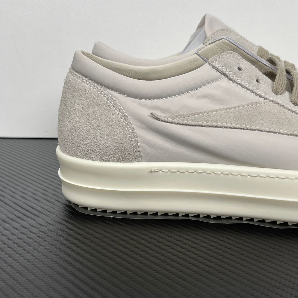 Side profile of the Rick Owens Mainline Vintage Sneaks in Pearl/Milk, featuring a sleek low-top silhouette with luxurious silk-nylon and suede spliced paneling, and a thick cream-colored outsole.