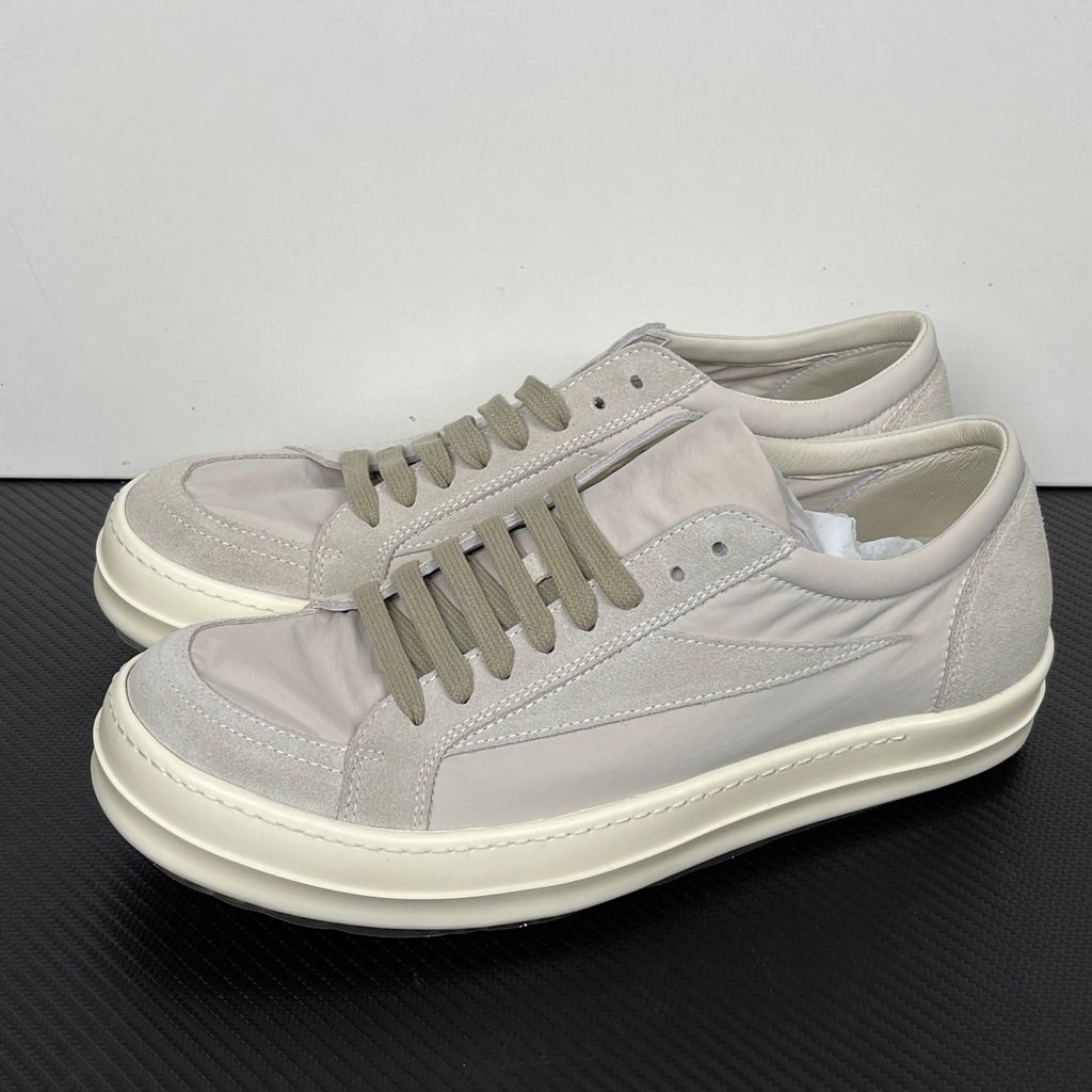 Side profile of the Rick Owens Mainline Vintage Sneaks in Pearl/Milk, featuring a sleek low-top silhouette with luxurious silk-nylon and suede spliced paneling, and a thick cream-colored outsole.