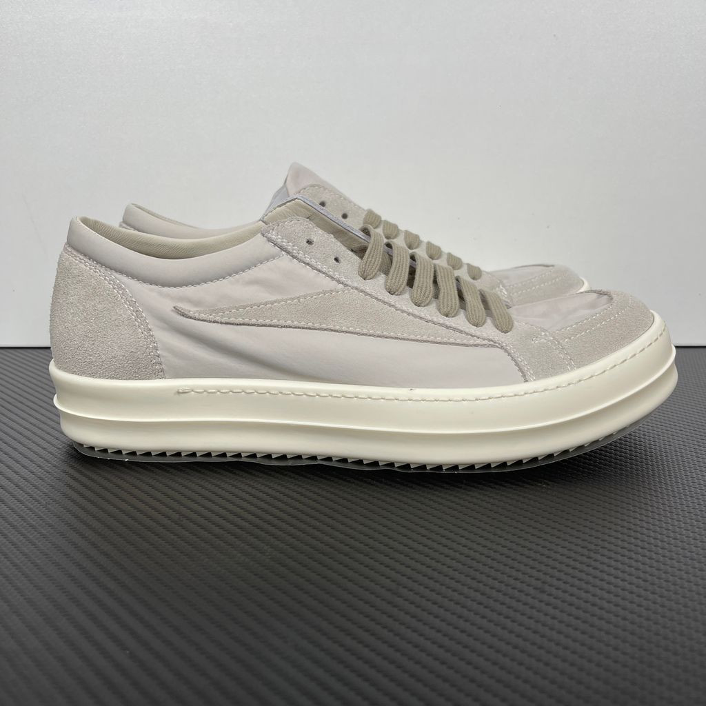Side profile of the Rick Owens Mainline Vintage Sneaks in Pearl/Milk, featuring a sleek low-top silhouette with luxurious silk-nylon and suede spliced paneling, and a thick cream-colored outsole.