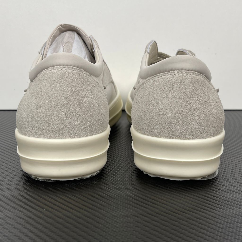 Side profile of the Rick Owens Mainline Vintage Sneaks in Pearl/Milk, featuring a sleek low-top silhouette with luxurious silk-nylon and suede spliced paneling, and a thick cream-colored outsole.