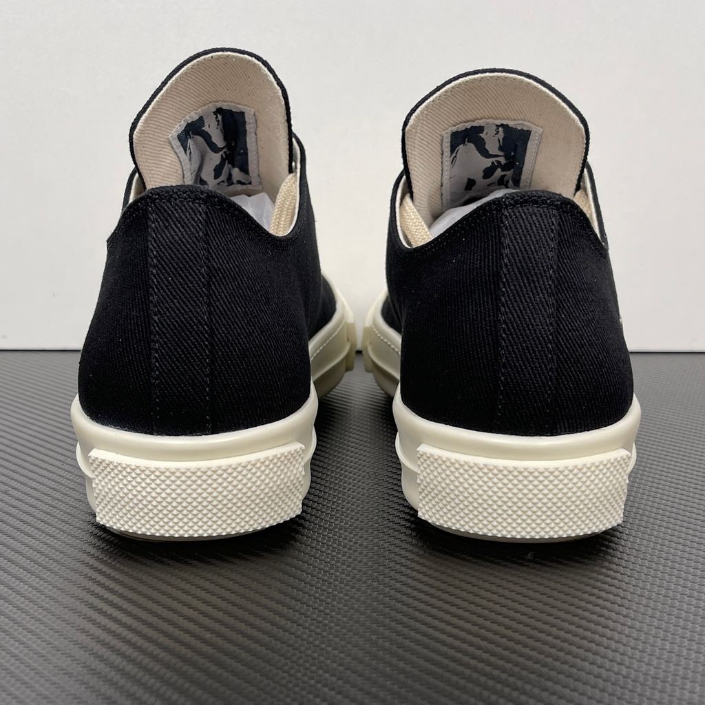 Side profile of the Rick Owens DRKSHDW Extreme Low Sneaks in Black canvas, showcasing the low-top silhouette, signature side metal eyelet row, and tonal rubber toe cap and midsole.