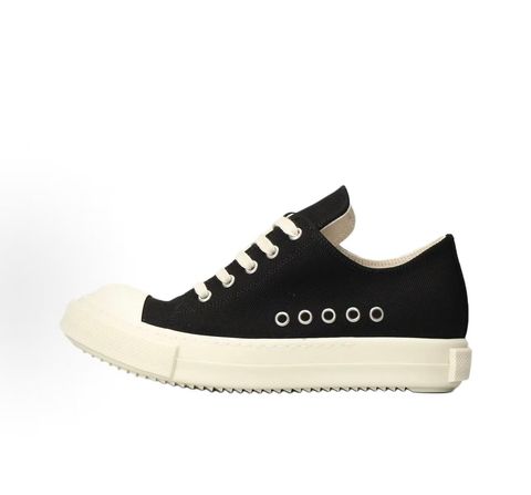 Side profile of the Rick Owens DRKSHDW Extreme Low Sneaks in Black canvas, showcasing the low-top silhouette, signature side metal eyelet row, and tonal rubber toe cap and midsole.