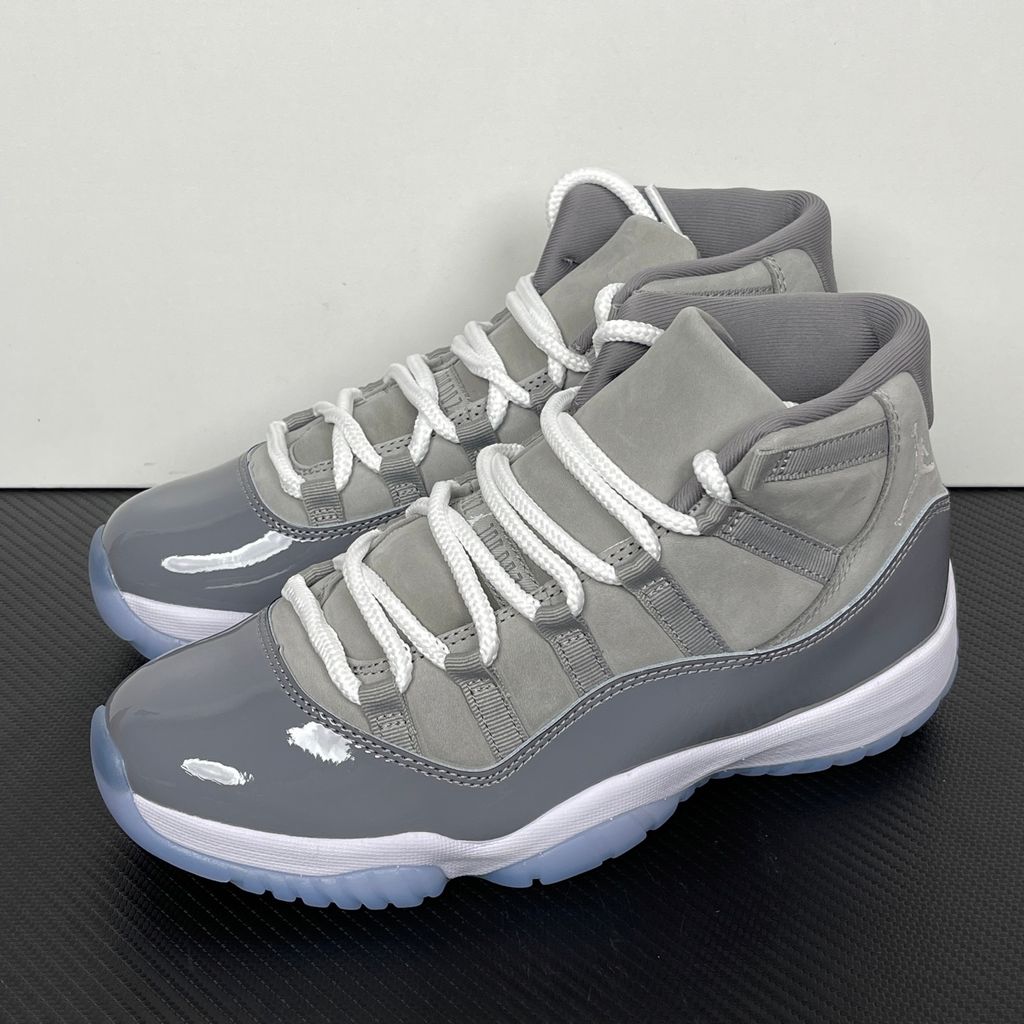 Side profile of the Air Jordan 11 Retro 'Cool Grey' (2021), showcasing the premium nubuck upper, signature high-cut grey patent leather mudguard, and white Phylon midsole.