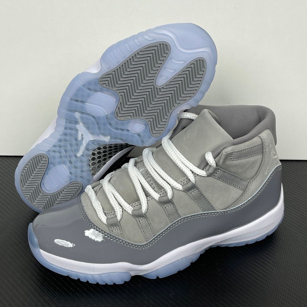 Side profile of the Air Jordan 11 Retro 'Cool Grey' (2021), showcasing the premium nubuck upper, signature high-cut grey patent leather mudguard, and white Phylon midsole.