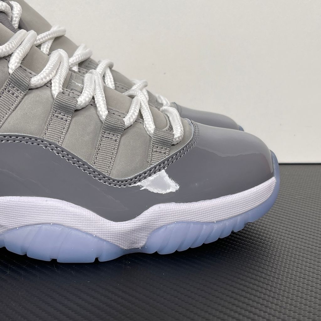 Side profile of the Air Jordan 11 Retro 'Cool Grey' (2021), showcasing the premium nubuck upper, signature high-cut grey patent leather mudguard, and white Phylon midsole.