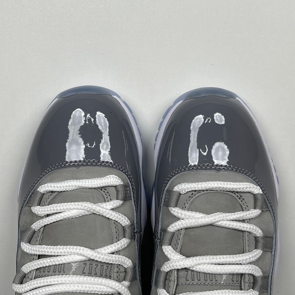 Side profile of the Air Jordan 11 Retro 'Cool Grey' (2021), showcasing the premium nubuck upper, signature high-cut grey patent leather mudguard, and white Phylon midsole.