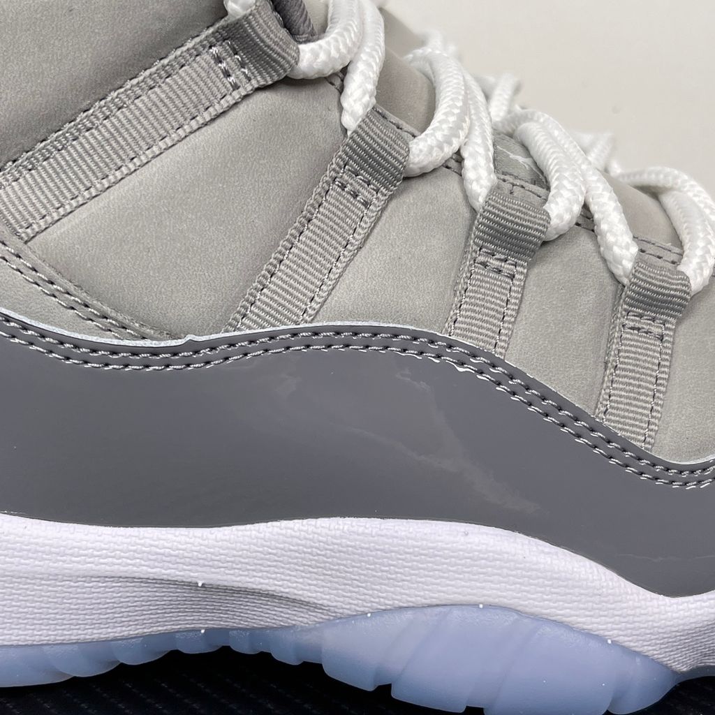 Side profile of the Air Jordan 11 Retro 'Cool Grey' (2021), showcasing the premium nubuck upper, signature high-cut grey patent leather mudguard, and white Phylon midsole.