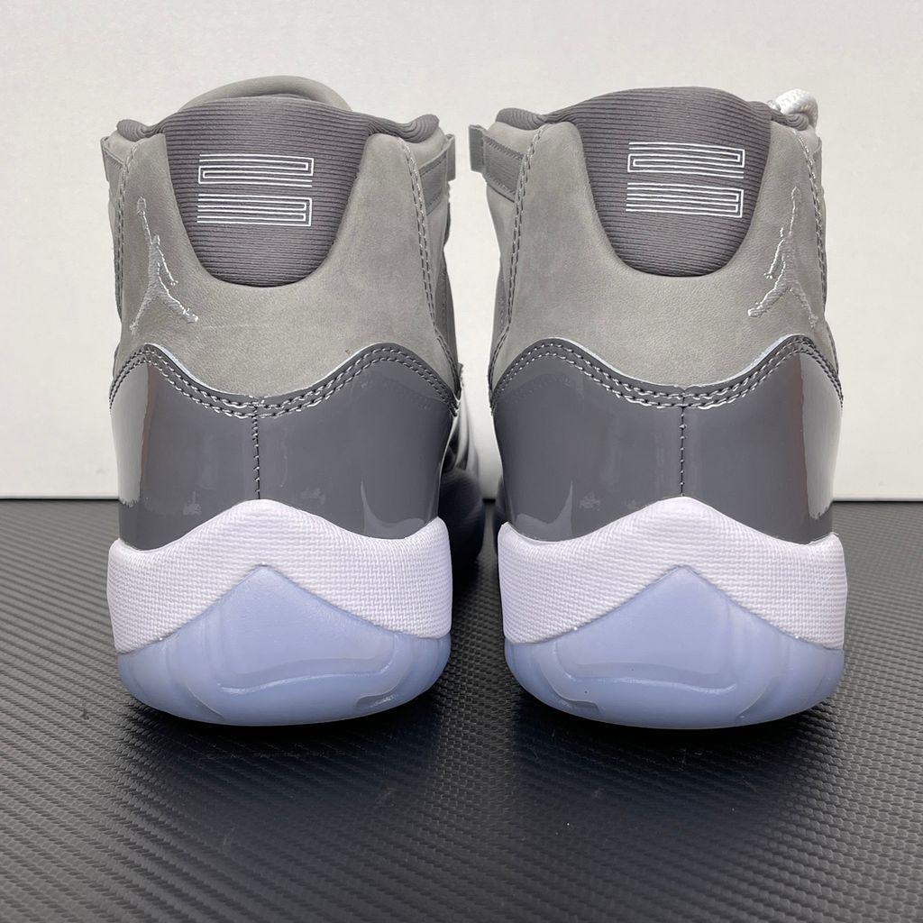 Side profile of the Air Jordan 11 Retro 'Cool Grey' (2021), showcasing the premium nubuck upper, signature high-cut grey patent leather mudguard, and white Phylon midsole.