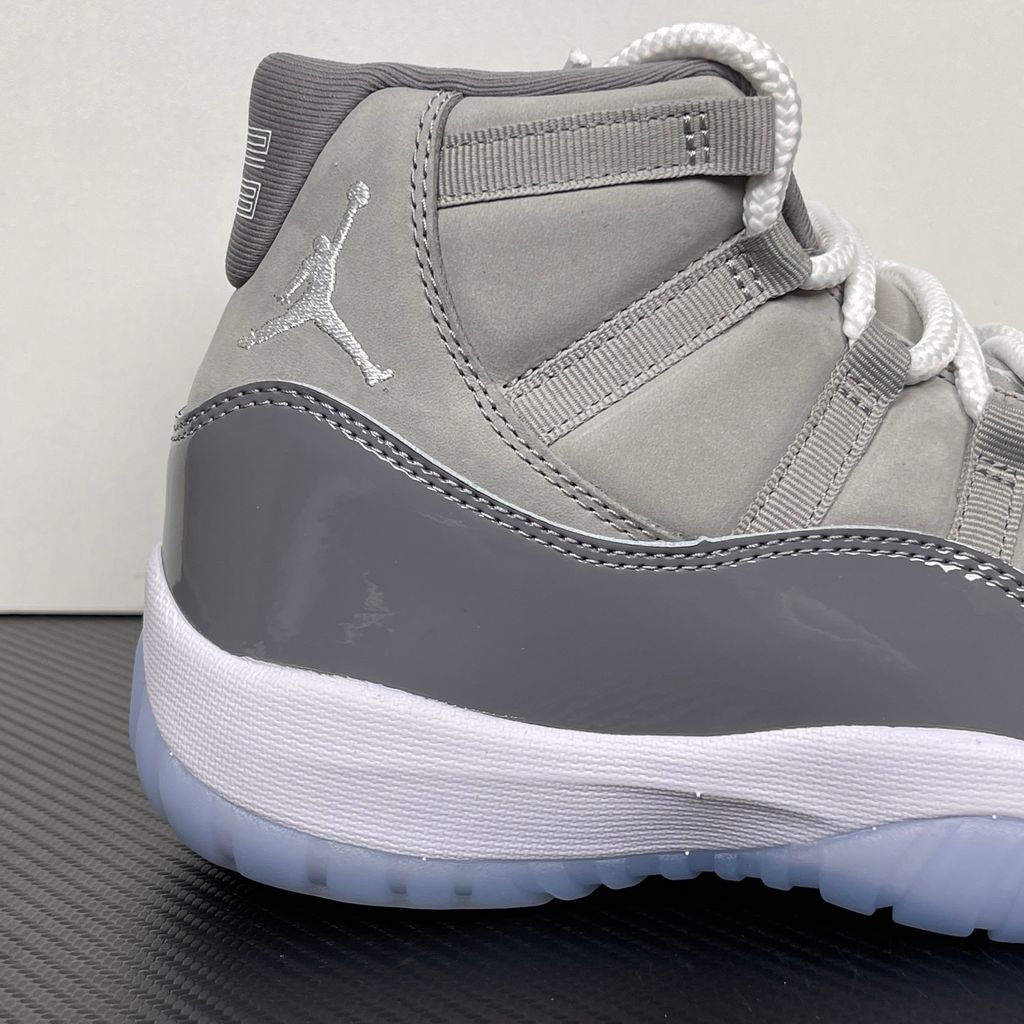 Side profile of the Air Jordan 11 Retro 'Cool Grey' (2021), showcasing the premium nubuck upper, signature high-cut grey patent leather mudguard, and white Phylon midsole.