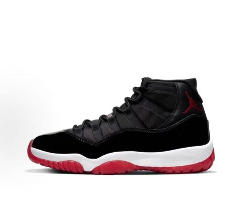 Side profile of the Air Jordan 11 Retro 'Bred' (2019), showcasing the black mesh upper, signature high-cut black patent leather mudguard, and crisp white Phylon midsole.
