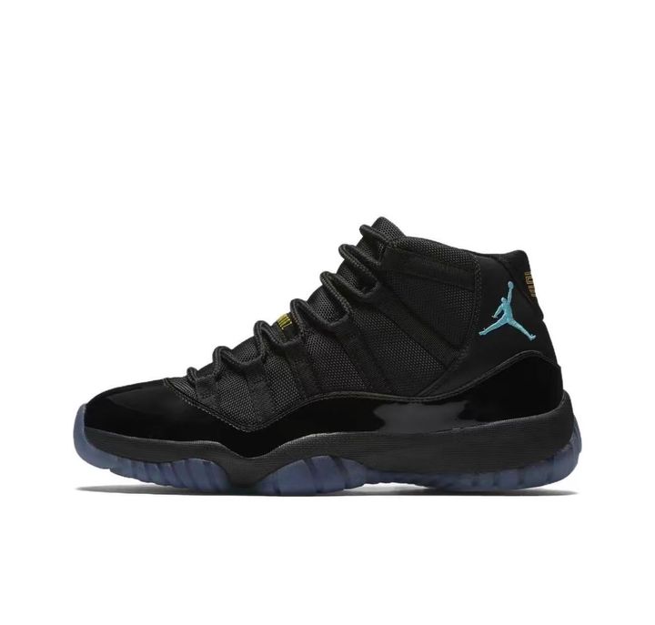 Side profile of the Air Jordan 11 Retro 'Gamma Blue' (2025), showcasing the all-black ballistic mesh upper, glossy high-cut patent leather mudguard, and black Phylon midsole.