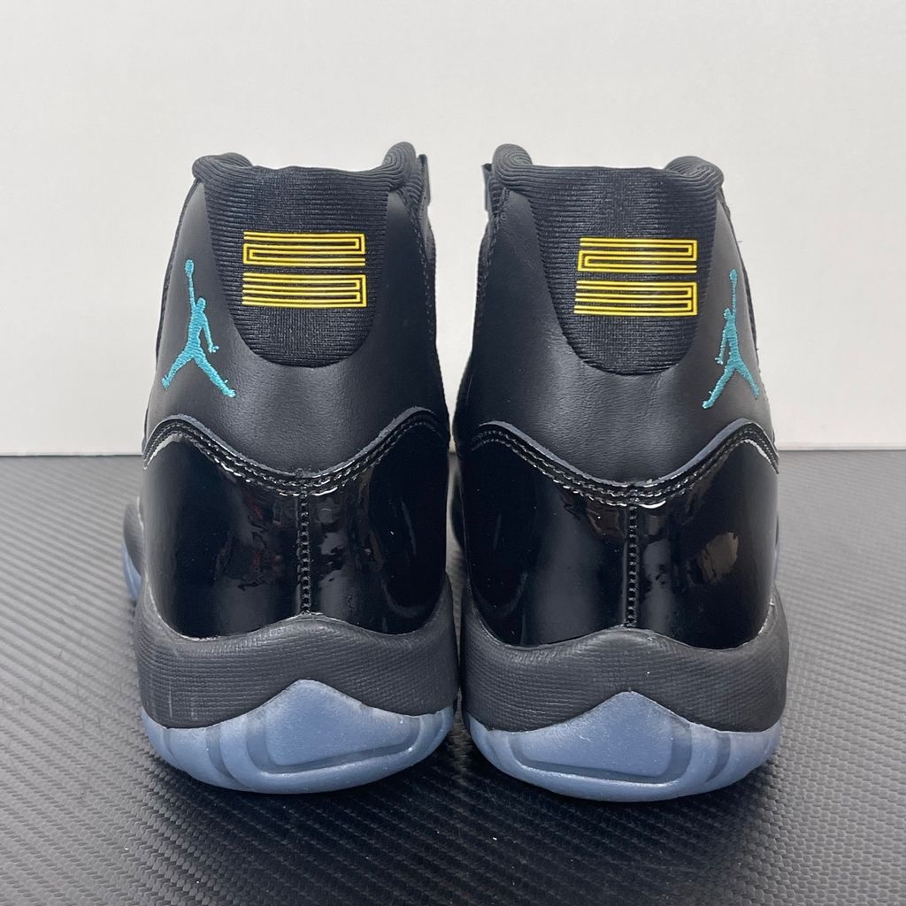 Side profile of the Air Jordan 11 Retro 'Gamma Blue' (2025), showcasing the all-black ballistic mesh upper, glossy high-cut patent leather mudguard, and black Phylon midsole.
