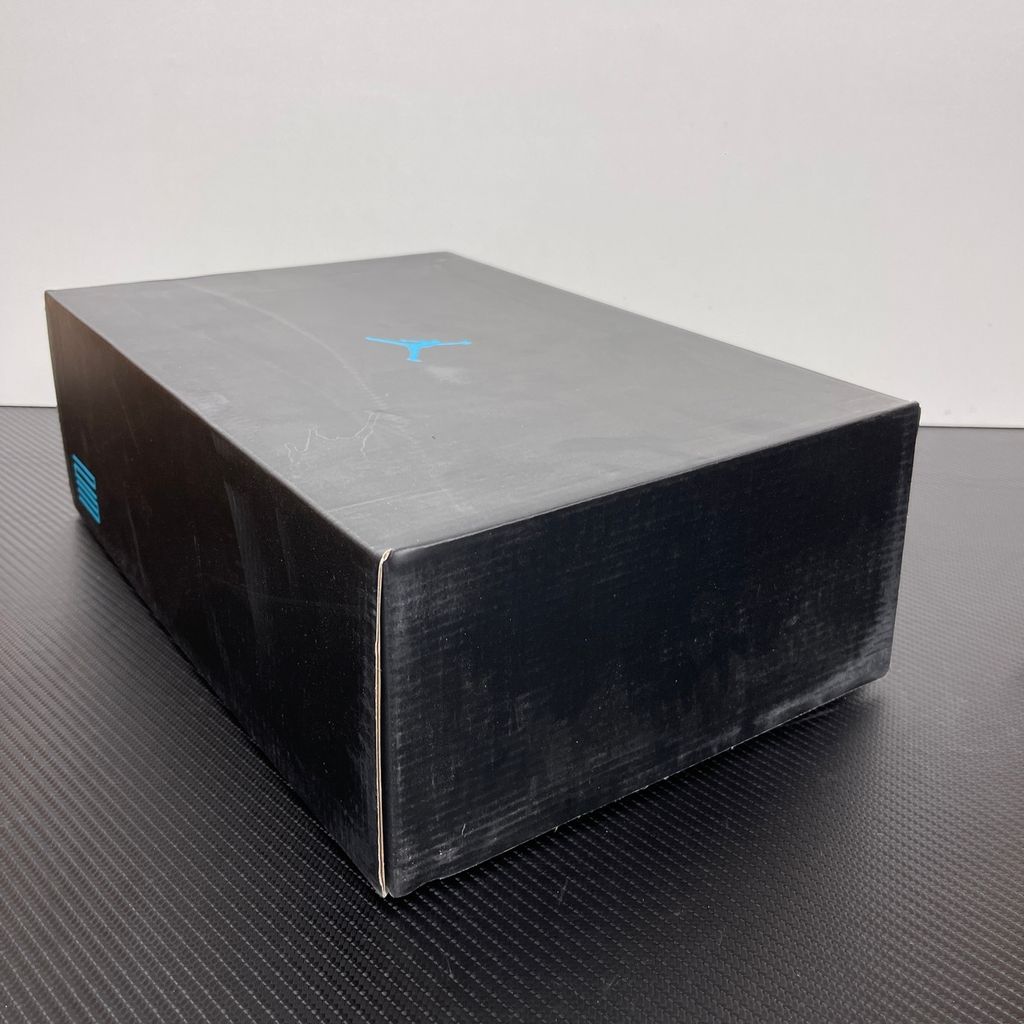 Side profile of the Air Jordan 11 Retro 'Gamma Blue' (2025), showcasing the all-black ballistic mesh upper, glossy high-cut patent leather mudguard, and black Phylon midsole.