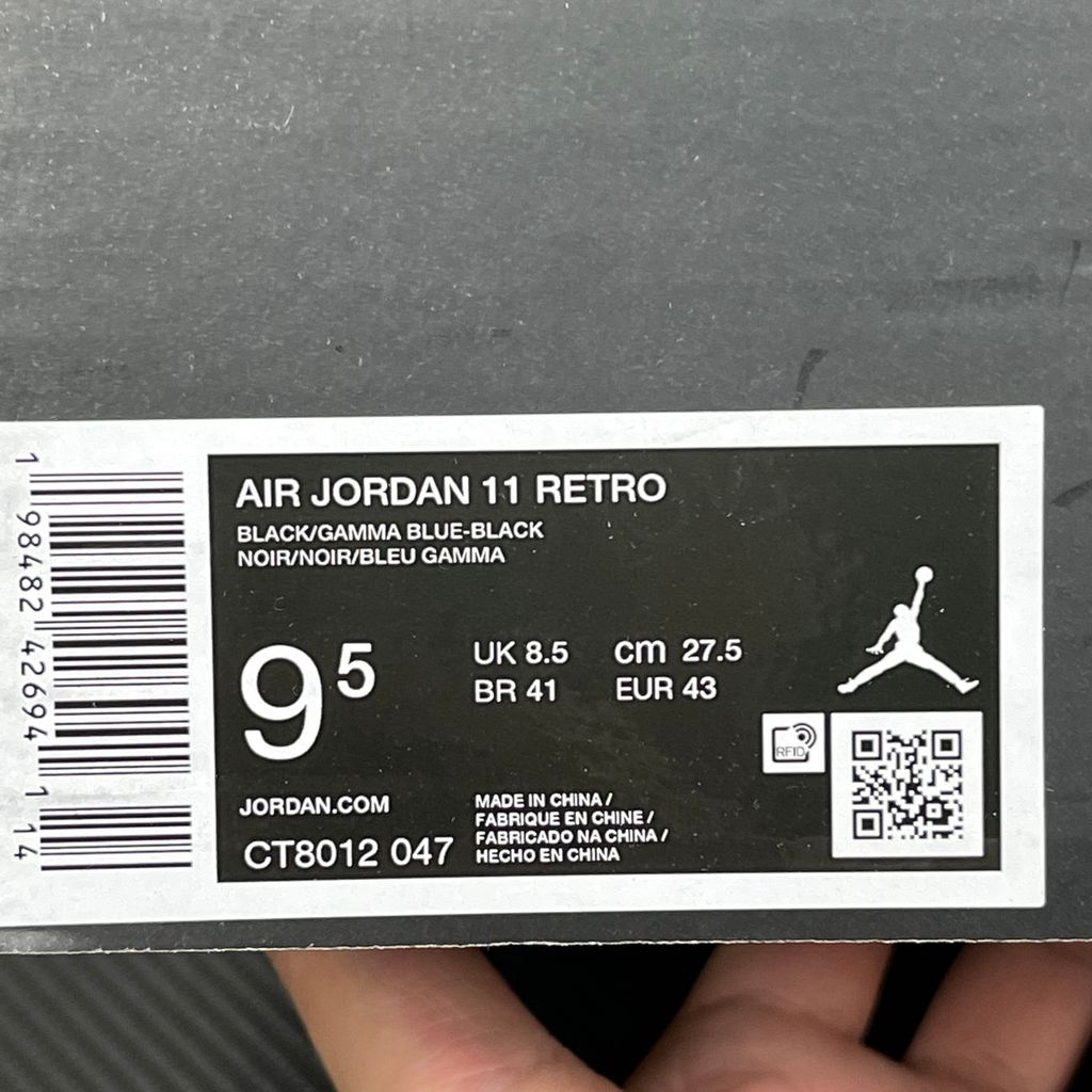 Side profile of the Air Jordan 11 Retro 'Gamma Blue' (2025), showcasing the all-black ballistic mesh upper, glossy high-cut patent leather mudguard, and black Phylon midsole.